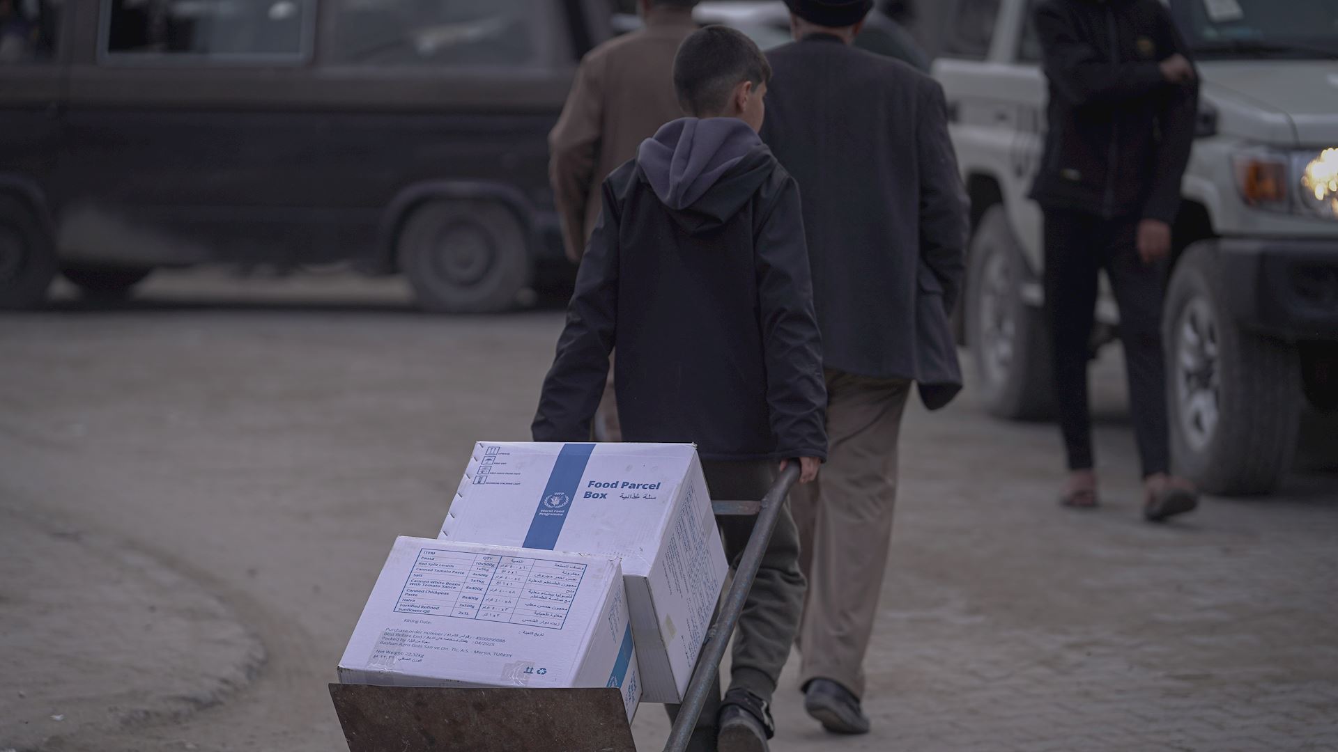 A child in Gaza carrying an emergency food parcel.