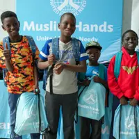 All smiles as students receive their new backpacks and get ready to head back to school. 