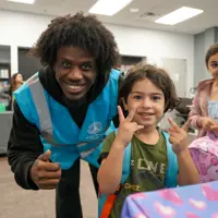 All smiles as children receive their new backpacks